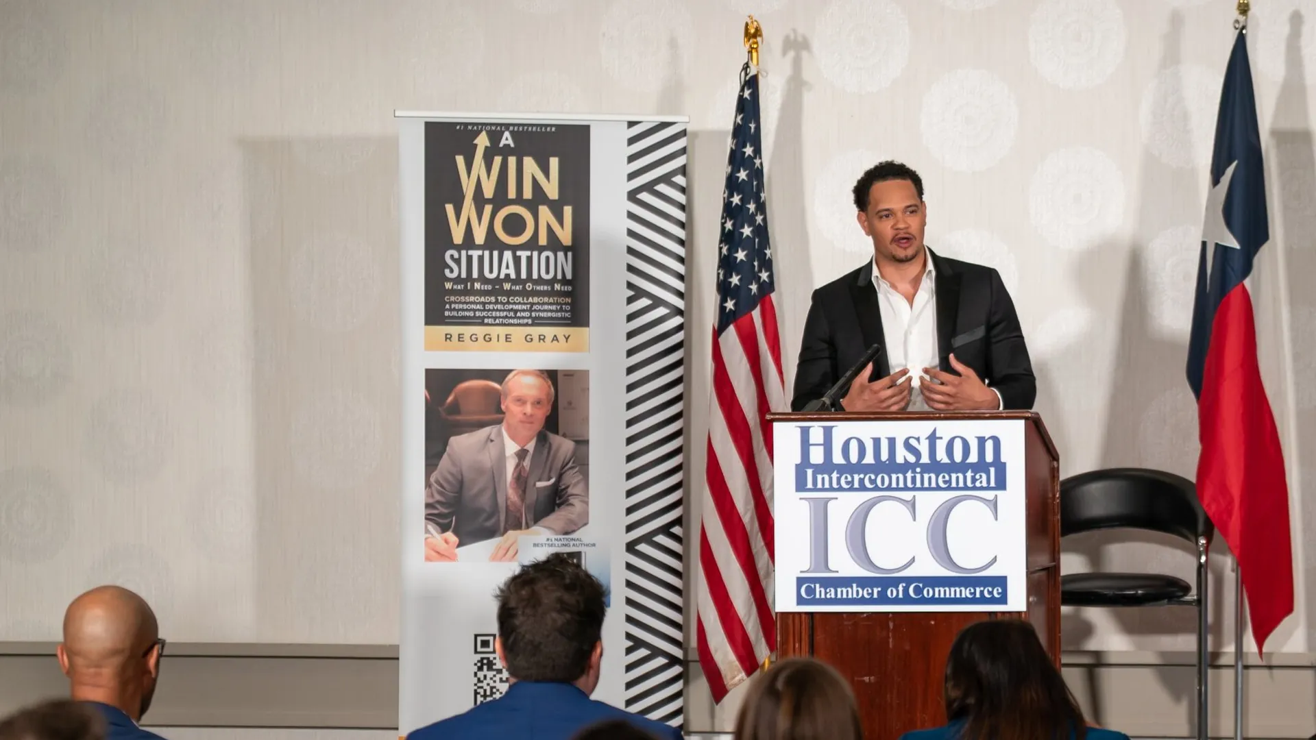 Kiva Geiger speaking from the podium at the Houston Intercontinental Chamber of Commerce