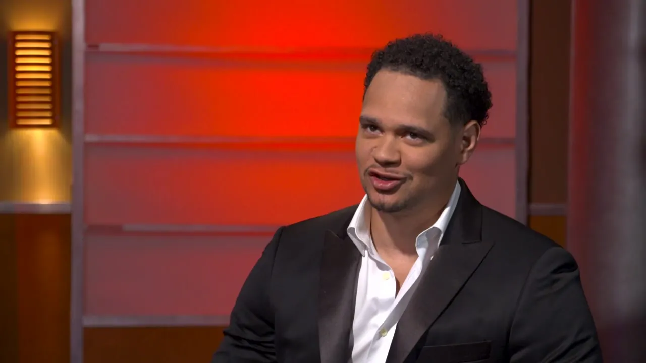 Kiva Geiger smiling mid-conversation in a television studio